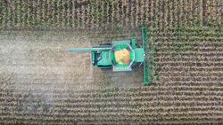 John Deere combine overhead shelling corn